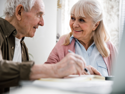 An older couple sits and discusses their plan. 