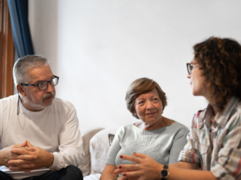 A family holds a family meeting in their living room