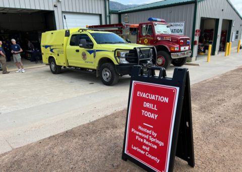 Photo of evacuation drill sign in front of Pinewood Springs fire station. 